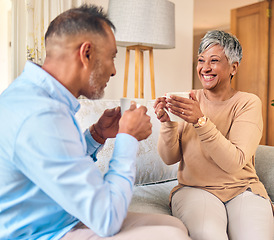 Image showing Coffee, retirement and a senior couple on a sofa in the home living room to relax while bonding in conversation. Smile, love or marriage with a mature man and woman talking while drinking a beverage