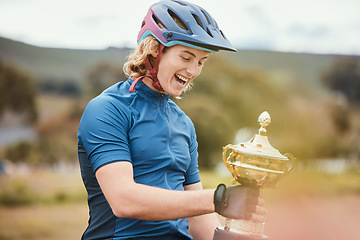 Image showing Winner, trophy and achievement with a woman cyclist in celebration of victory outdoor after a race. Award, motivation and success with a happy young female athlete winning a cycling competition