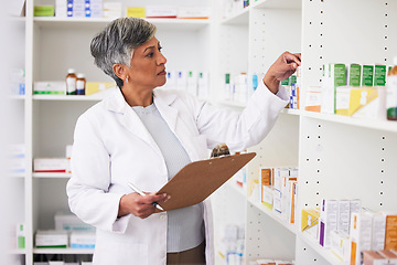 Image showing Pharmacy, writing and clipboard of woman with medicine on a shelf for pharmacist inventory. Mature female employee in healthcare, pharmaceutical and medical industry reading information on stock