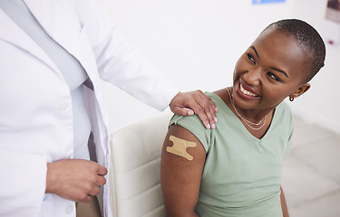 Image showing Doctor, patient and plaster on arm for vaccine, medicine and protection for virus with happy black woman in clinic. Medic, african girl and smile for helping hand, injection and strong immune system