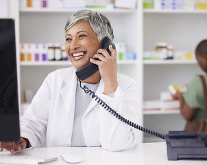 Image showing Pharmacist, conversation and customer service with telephone for call with computer. Female chemist, working and online for communication for job with tech for help with medicine at drugstore.