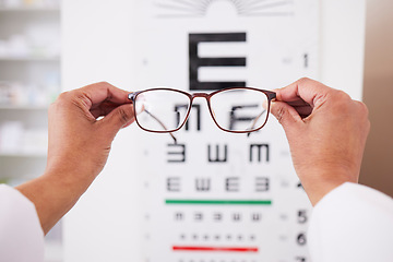Image showing Glasses in hands, optometry and vision, eye care and health with eyesight test and chart, prescription lens and frame. Ophthalmology, focus and healthcare, person in optometrist clinic and eyewear