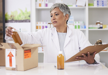 Image showing Woman, doctor and box at pharmacy for inventory inspection, logistics or delivery at drug store. Senior female person, medical or healthcare professional checking pharmaceutical stock or medication