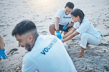 Image showing Charity, teamwork and cleanup at beach for recycling in environment with help for community. Volunteers, together and ocean or sand with cleaning, pollution and eco friendly service in nature.