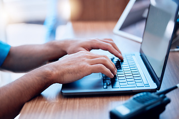 Image showing Laptop, radio and hands of security typing or writing an investigation project at a law enforcement office. Police, keyboard and person or officer working on internet crime and criminal email online