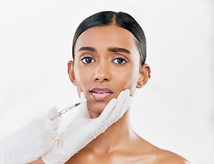 Image showing Injection, scared and portrait of woman with face filler of beauty process on white background in studio. Cosmetics, indian female model and fear of needle, plastic surgery or aesthetic facial change