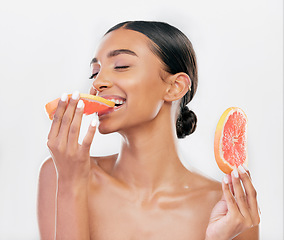 Image showing Eating, grapefruit and Indian woman with natural beauty, skincare and cosmetics for healthy glow, citrus or vitamin c. Face, skin care and eat fruit for wellness, health of body and white background