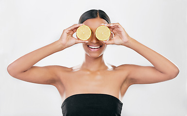 Image showing Indian woman, portrait with lemon for beauty, skincare and natural cosmetics for healthy glow, citrus or vitamin c. Face, eyes and skin care with fruit for wellness, health and white background
