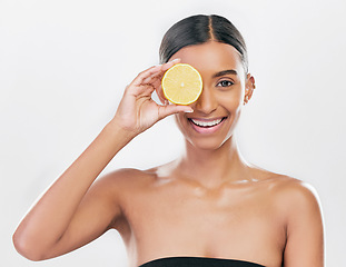 Image showing Happy, lemon and portrait of a woman for skincare, beauty glow or vitamin c for health. Smile, wellness and an Indian model or girl with fruit for diet isolated on a white background in a studio