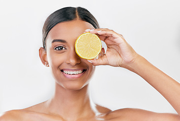 Image showing Happy, lemon and portrait of a woman for nutrition, beauty glow or vitamin c for skincare. Smile, wellness and an Indian model or girl with fruit for diet isolated on a white background in a studio