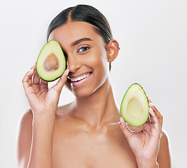 Image showing Face, avocado and natural beauty, woman with organic cosmetics and facial on white background. Eco friendly skincare, healthy skin glow and female model in portrait, fruit and dermatology in studio