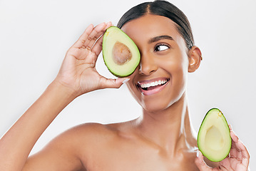 Image showing Avocado, skincare and happy, beauty woman isolated on a white background for healthy facial and cosmetics ideas. Indian woman or model thinking of vegan, eco friendly or dermatology product in studio