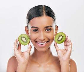 Image showing Skincare, health and portrait of a woman with kiwi for nutrition, diet and wellness. Happy, spa treatment and an Indian girl or model with fruit or food for facial isolated on a white background