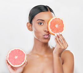 Image showing Indian woman, portrait with grapefruit for beauty, skincare and natural cosmetics for healthy glow, citrus or vitamin c. Face, emoji and skin care with fruit for wellness, health and white background