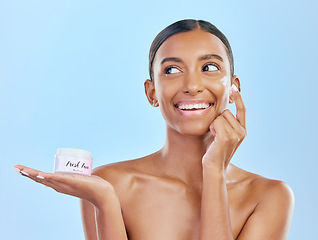 Image showing Face, cream in hand and beauty, woman with skincare and cosmetics product isolated on blue background. Lotion, sunscreen and facial mask, smile and moisturizer with female model and dermatology