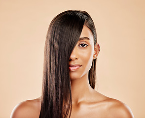 Image showing Hair care, cosmetics and portrait of a woman on a studio background with salon treatment. Beauty, healthy and headshot of an Indian model or girl showing shampoo results isolated on a backdrop