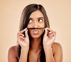 Image showing Face, skincare and hair mustache with a woman in studio on a cream background for keratin treatment. Beauty, haircare and funny with happy young female looking playful at the salon or hairdresser