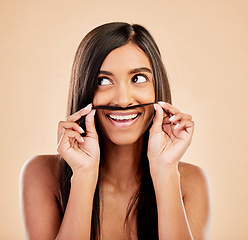 Image showing Face, beauty and hair mustache with a woman in studio on a cream background for keratin treatment. Skincare, haircare and funny with happy young female looking playful at the salon or hairdresser