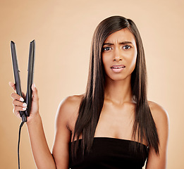 Image showing Flat iron, hair and woman is confused with beauty, hairstyle and appliance fail on studio background. Keratin treatment, problem with electric straightener and female model with haircare crisis