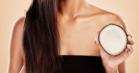 Image showing Closeup, woman or coconut of hair, beauty or cosmetic treatment for natural growth, sustainable cosmetics or studio background. Female model, tropical fruits or vegan dermatology of healthy hairstyle