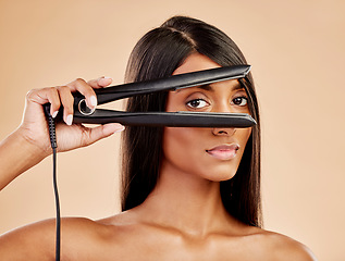 Image showing Flat iron, hair and woman with beauty, portrait and hairstyle with appliance isolated on studio background. Keratin treatment, electric straightener and heat, Indian female model with cosmetology