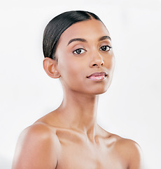 Image showing Beauty, face and portrait a woman with natural skin care on a blue background with cosmetics. Dermatology, makeup glow and Indian female model for facial shine, wellness and self love in studio