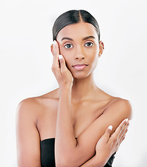 Image showing Beauty, hand on face and portrait a Indian woman with natural skincare isolated on a white background. Dermatology, makeup glow and cosmetics with female model for facial shine or self care in studio