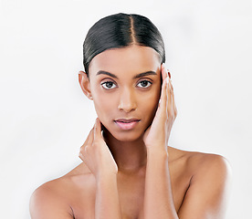 Image showing Portrait, beauty and face of a serious woman with natural skin glow isolated on a white background. Dermatology, makeup or cosmetics of Indian person for facial shine, wellness or self care in studio