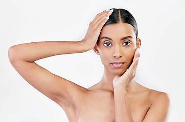 Image showing Hands on face, skin care and woman portrait for natural beauty isolated on a white background. Dermatology, makeup glow and cosmetics with Indian female model for facial shine and self love in studio