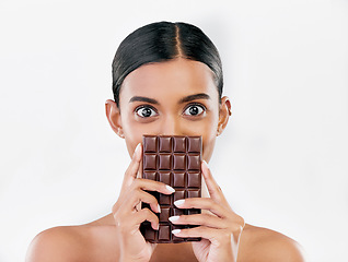 Image showing Woman, portrait and chocolate in sweet diet or unhealthy eating against a white studio background. Female person or model with cocoa slab, block or bar in delicious treat, snack or diabetes on mockup