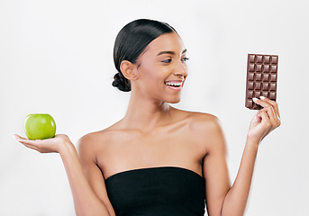 Image showing Apple, chocolate and woman with healthy food choice or offer isolated on studio, white background for sugar and diet. Dessert, green fruit and young person with detox, vegan or lose weight decision