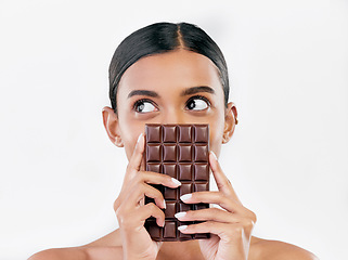 Image showing Woman, thinking and chocolate in sweet diet or unhealthy eating against a white studio background. Female person or model with cocoa slab, block or bar in delicious treat, snack or diabetes on mockup