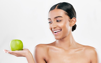 Image showing Beauty, woman and apple in hands for skincare and natural glow isolated on white background. Dermatology, health and wellness of Indian person with facial, benefits and fruit for self care in studio