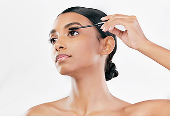 Image showing Beauty, mascara and makeup of a woman with natural glow isolated on a white background. Eyelash, cosmetics and lash brush of Indian female model for facial shine, application and self care in studio