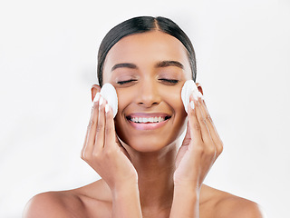 Image showing Woman, smile and cotton pad for face, cosmetics and aesthetic skincare in studio on white background. Happy indian female model with beauty products for cleaning, facial dermatology or makeup removal