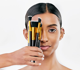 Image showing Portrait, skincare and woman with makeup, brushes and organic facial against a white studio background. Face, female person and model with cosmetics tools, natural beauty and luxury with wellness