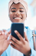 Image showing Phone, business and black woman typing in city for social media, internet and online conversation. Travel, blue sky and face of happy female person on smartphone for chatting, website and networking