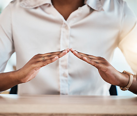 Image showing Hand gesture, insurance and a black woman broker at a desk in her office for home loan, mortgage or cover. Hands, security and safety with a female agent sitting in the workplace for a surety offer