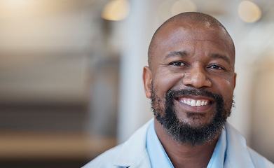 Image showing Face, black man and happy doctor in hospital for healthcare, wellness and mockup space. African medical professional, portrait and surgeon, person or employee from Nigeria with smile for health bokeh