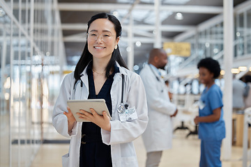 Image showing Asian woman, portrait and happy doctor with tablet in hospital for healthcare, telehealth and research. Medical professional, face and surgeon, worker or employee with glasses for wellness technology