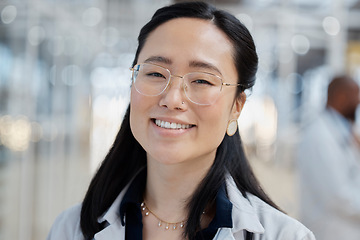 Image showing Asian woman, face and happy doctor in hospital for healthcare, wellness and glasses. Medical professional, portrait and female surgeon, worker and employee with smile for health bokeh in clinic.