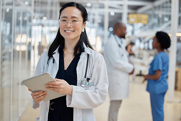 Image showing Asian woman, doctor with tablet and portrait smile in hospital for healthcare, telehealth and research. Medical professional, face and surgeon, worker or employee with glasses for wellness technology