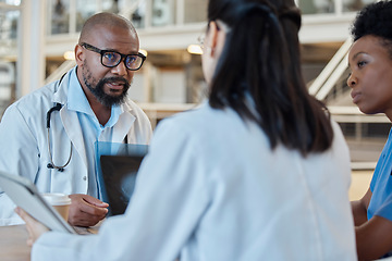 Image showing Black man, radiology doctors and discussion with xray of test results, research and healthcare meeting. Medical team, surgeon and nursing staff planning surgery assessment for x ray report of anatomy