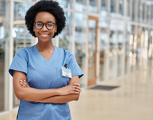 Image showing Nurse, portrait and black woman with arms crossed, happy or smile in hospital. African medical professional, confidence and face of surgeon from Nigeria with glasses for healthcare service in clinic.