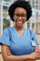 Image showing Portrait, nurse and black woman with arms crossed, smile or happy in hospital. African medical professional, confidence and face of surgeon from Nigeria with glasses for healthcare service in clinic.