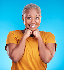 Image showing Portrait, smile and black woman with hand on face with confidence in blue studio background. Beauty, cosmetic and girl with fashion or positive mindset for wellness or happiness and excited face.