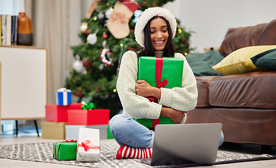 Image showing Woman, Christmas present and laptop, video call and celebrate holiday, happiness and communication. Virtual conversation, contact on pc and female person at home with gift giving, package and smile