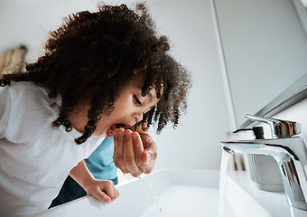 Image showing Child, dental health and water to rinse mouth with hand of a parent at a bathroom basin for wellness. African girl kid learning about brushing teeth for morning routine at home with a parent for help