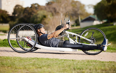 Image showing Cycling, fitness and cardio with man and handcycle in nature for training, sports and challenge. Exercise, workout and marathon with person with a disability in park for wellness and health on road