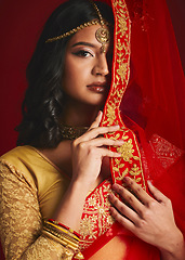 Image showing Fashion, traditional and portrait of Indian woman with veil in ethnic clothes, jewellery and sari. Religion, beauty and female person on red background with culture accessory, cosmetics and makeup